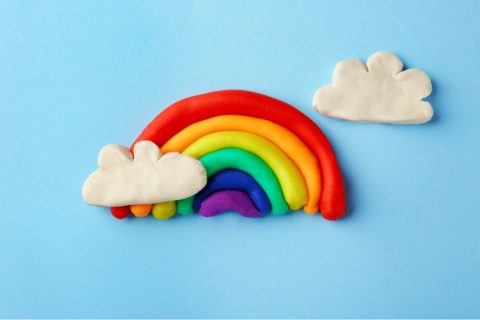 a bright rainbow and clouds made of play doh